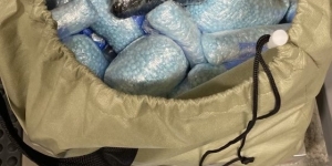Blue M-30 Fentanyl pills in a bag and on scale with a weight of 43 lbs. showing 
