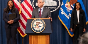 Attorney General Merrick B. Garland delivers remarks from a podium bearing The Department of Justice seal.