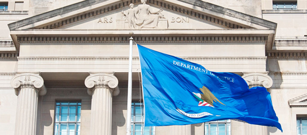 Department of Justice flag in front of the main Department of Justice image