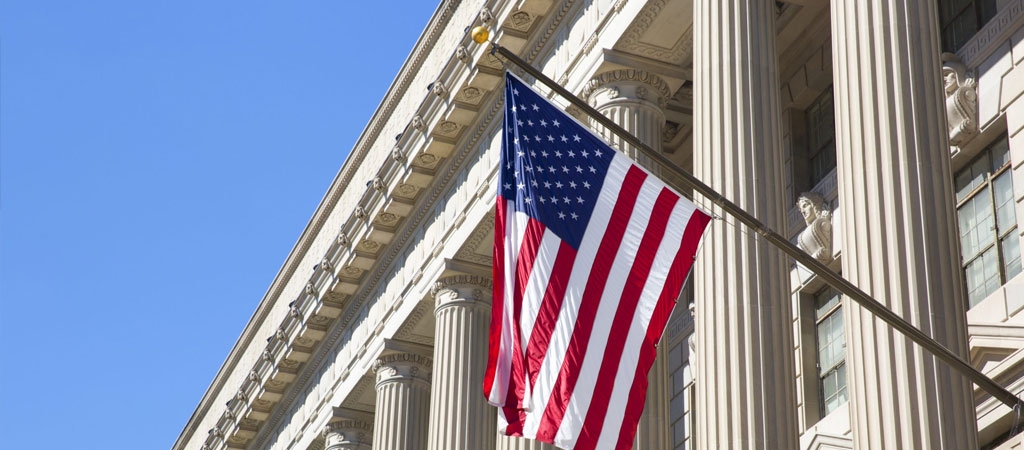 An American flag hangs from a government office building