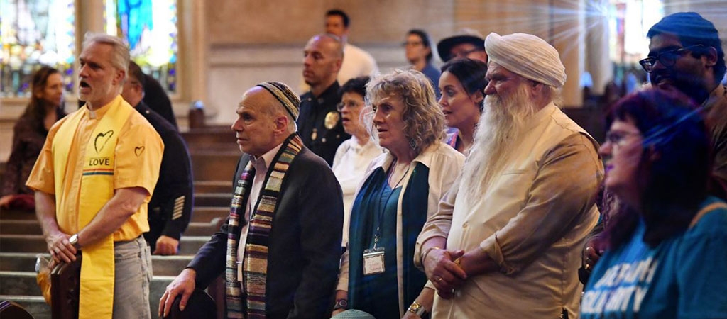 Religious leaders from up to 12 different faiths listen to a service to denounce religious intolerance