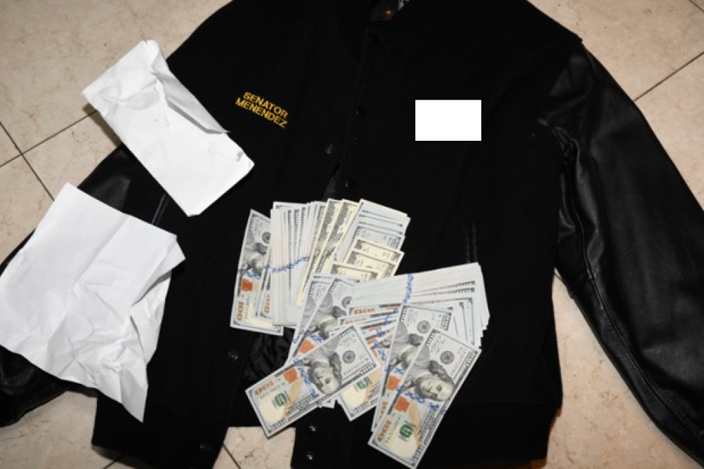 Image of stacks of hundred dollar bills with a leather jacket embroidered with Senator Menendez's name