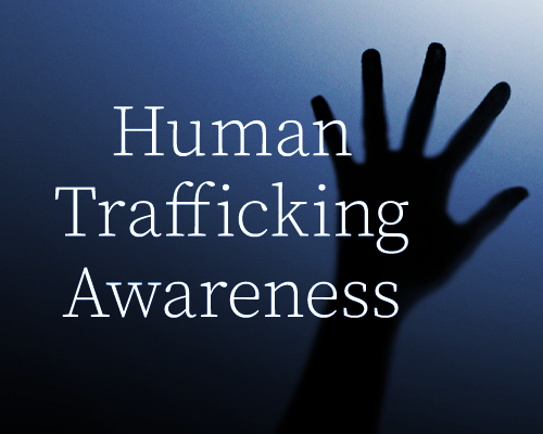 Human Trafficking Awareness text with silhouette of hand in background 