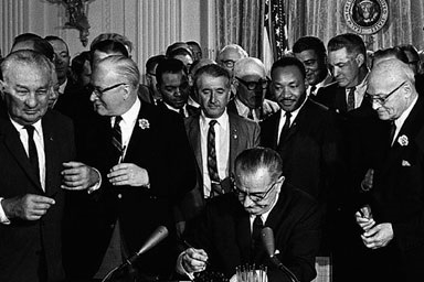 President Lyndon Baines Johnson signs the Civil Rights Act of 1964