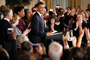 President Barack Obama stands on stage with Dennis and Judy Shepard, parents of Matthew Shepard, and Louvon Harris and Betty Byrd Boatner, sisters of James Byrd, Jr., during his remarks marking the enactment of the Matthew Shepard and James Byrd, Jr., Hate Crimes Prevention Act, in the East Room of the White House, October 28, 2009.